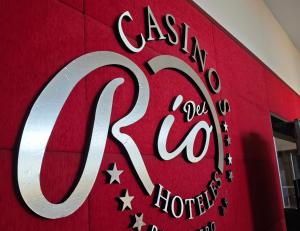 un panneau pour un hôtel casilla sur un mur rouge dans l'établissement Hotel y Casino Del Río - Las Grutas, à Las Grutas
