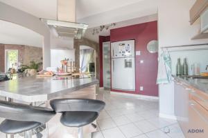 a kitchen with a counter and stools in it at La Lilla - Wifi - Piscine - Parking in Chauvé