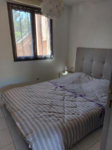 Postel nebo postele na pokoji v ubytování Marina-Di-Pinarello Corse-du-Sud à 400m de la plage Pinarellu