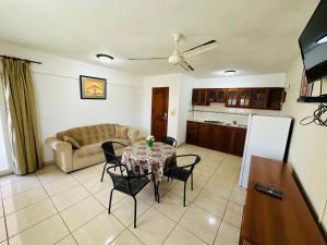 a living room with a table and chairs and a couch at Apartmenthotel Michaela in Sosúa