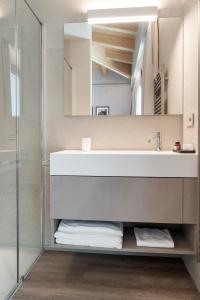 a bathroom with a sink and a mirror at Lago Dorato Marina Lodge - Lakefront in Colico +77 photos
