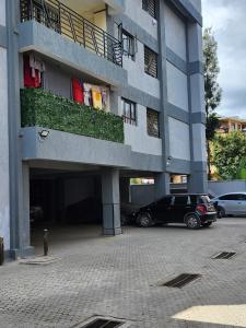 a car parked in a parking lot in front of a building at kingdom corner suites in Nairobi +5 photos