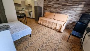 a small room with a bed and a kitchen at The Marchisio Apartment in Buggerru