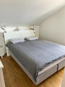 a bedroom with a large bed with two pillows at Ivana Rogoznica in Rogoznica