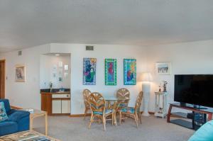 una sala de estar con una mesa y sillas en Mermaids Cove, en Nags Head