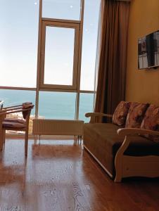 a bedroom with a bed and a large window at Аркадия с панорамой моря in Odesa