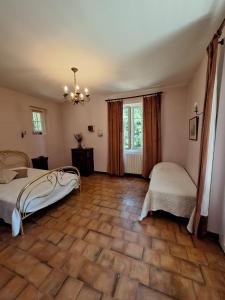 a bedroom with two beds and a large window at Le Manoir de la Feuillade in Carsac-Aillac +31 photos