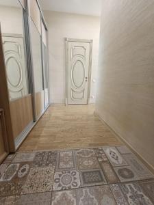 an empty hallway with a door and a tile floor at Аркадия с панорамой моря in Odesa +9 photos