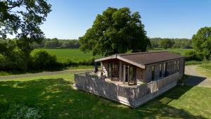 a small cabin in the middle of a field at Curlew Lodge Yorkshire in West Tanfield