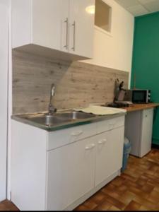 a kitchen with a sink and a counter top at Carcassonne Studio in Carcassonne