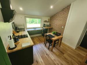 a kitchen with a counter and a table in a room at La Couleuvre in Beaujeu-Saint-Vallier-et-Pierrejux +29 photos
