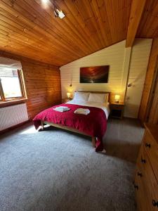a bedroom with a bed in a wooden room at The Retreat in Berrynarbor