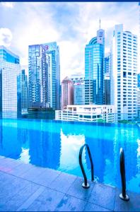 a swimming pool in front of a city skyline at CozyNest Suites Bukit Bintang in Kuala Lumpur