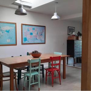 a dining room with a wooden table and chairs at Casa del Cerrito in Tandil +2 photos