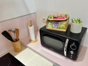 a microwave on a counter with a box of food on it at Rosalie - Bienvenue dans le cœur historique de Troyes in Troyes +10 photos