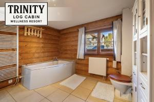 bagno con vasca e servizi igienici di TRINITY Log Cabin Wellness resort a Štrba