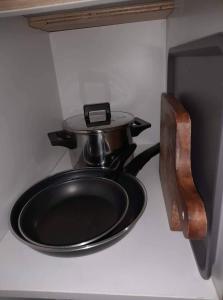 a stove with a frying pan on top of it at The Donegal with WI-FI Netflix Parking with fee in Manila