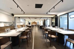 a dining room with long tables and chairs at Terra Vinum in Neméa
