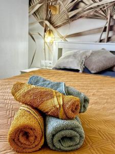 a pile of towels sitting on top of a bed at F3Sun CASA JACOB - 2 BR, Green Oasis, Costa Calma, Fuerteventura in Costa Calma +34 photos
