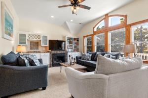 a living room with two couches and a fireplace at Ocean Escape in Corolla
