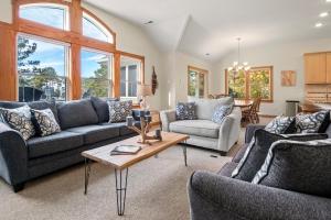 a living room with two couches and a table at Ocean Escape in Corolla +66 photos