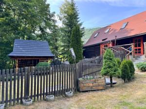 a wooden fence in front of a wooden house at Chatka pod orechom in Terchová