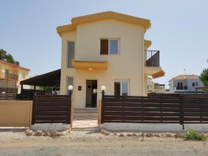 a house with a fence in front of it at SeaBreeze Villas by TrulyCyprus in Ayia Napa