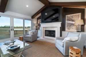 a living room with a fireplace and a tv at 3145 Green Heron Court in Seabrook Island