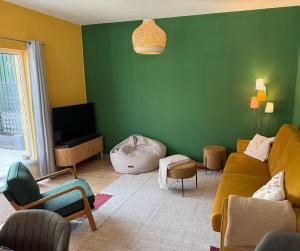 a living room with a couch and a green wall at Zechenstube in Elbingerode