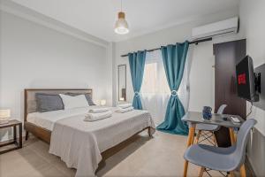 a bedroom with a bed and a blue curtain at Athens Urban Lifestyle Apartments in Athens