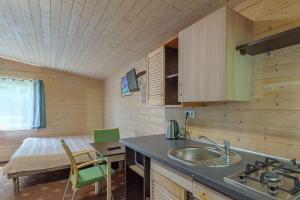 a kitchen with a sink and a table in a room at Pylimo slėnis in Palanga +51 photos