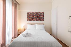 a bedroom with a bed with a towel on it at Rotunda Living Nr12 in Thessaloniki