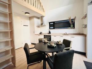 a kitchen and dining room with a table and chairs at Herberg de Bos in Swalmen +7 photos