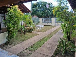 a walkway in a garden with trees and plants at CASA DE PRAIA CAJUEIRO ALTER in Alter do Chao