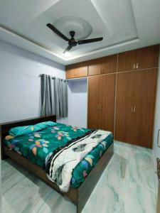 a bedroom with a bed and a ceiling fan at Comfortable Budget Stay at ServoStay NonAC Rooms in Tirupati Ideal for Pilgrims in Tirupati +7 photos