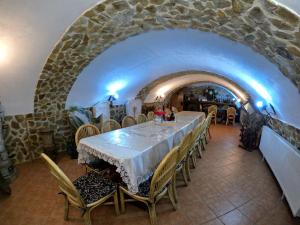 a dining room with a long table and chairs at Mehadica House in Mehadica +27 photos