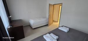 a room with a bed with two towels on it at Apartmán u Jeleňa in Kežmarok