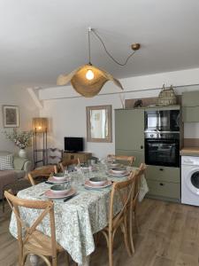 a kitchen and dining room with a table and chairs at Le petit traîne-feuilles in Saint-Aignan