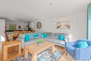 a living room with a couch and a table at House 4 in Looe