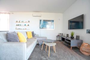 a living room with a couch and a table at Casa Luz by LovelyStay in Prazeres