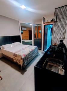 a bedroom with a bed and a sink at UrbanStay Flats in João Pessoa