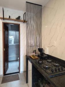 a kitchen with a counter top and a stove at UrbanStay Flats in João Pessoa +8 photos