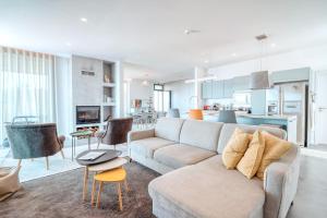 a living room with a couch and a table at Casa Luz by LovelyStay in Prazeres