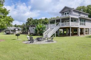 una casa con dos sillas y una parrilla en el patio en Riverfront Family Retreat with Yard in Saint Amant, en Port Vincent