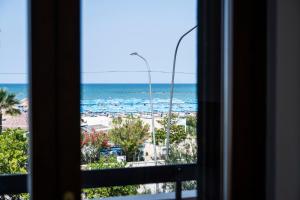 a view of the beach from a window at Comfort Vista Mare - Alba sul Mare in Pescara