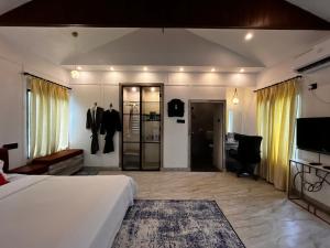 a hotel room with a bed and a desk at Riverside Burrows in Jabalpur +13 photos