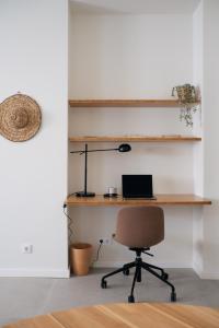 a room with a desk with a chair and a laptop at Outsite Sagres in Sagres +8 photos