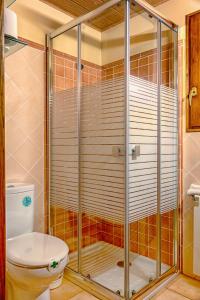 a shower stall with a toilet in a bathroom at Fonda Angeleta in Valderrobres