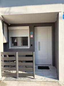a house with a white door and a window at Vt Homes in Corfu