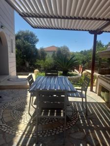 a blue table and chairs on a patio at Panselinos in Meganisi